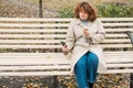 mobile communication autumn day woman phone bench Royalty Free Stock Photo