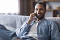 Mobile Communication. Portrait Of Smiling Black Man Talking On Cellphone At Home Royalty Free Stock Photo