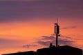 Mobile communication tower antenna as silhouette in a beautiful sunset orange and blue sky shows modern technology infrastructure Royalty Free Stock Photo