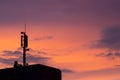 Mobile communication tower antenna as silhouette in a beautiful sunset orange and blue sky shows modern technology infrastructure Royalty Free Stock Photo