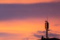 Mobile communication tower antenna as silhouette in a beautiful sunset orange and blue sky shows modern technology infrastructure Royalty Free Stock Photo