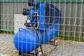 Mobile compressor unit with electric motor and large cylinder receiver. Special equipment for playground. Painted in blue.
