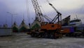 Mobile construction cranes with arms and big tower cranes. At the port of Sunda Kelapa on sky background