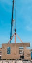 THE MOBILE CRANE LIFTING A PANEL PRECAST TO ThE SLOOF OF Royalty Free Stock Photo