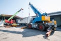 Mobile crane operating by lifting and moving an heavy Royalty Free Stock Photo