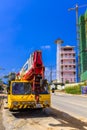 Mobile crane parked on a side of a road