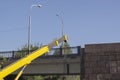 A mobile crane performs cargo work on a road bridge