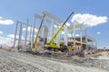 Mobile crane is unloading concrete joist from truck trailer