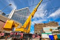 Mobile crane at work at downtown construction site Royalty Free Stock Photo