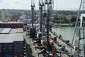 Mobile cranes operated by stevedores viewed from container ship with cranes. Royalty Free Stock Photo