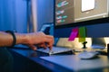 Mobile developer writes program code on a computer, typing on keyboard, programmer work in home office Royalty Free Stock Photo