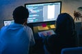 Mobile developers team writes program code on a computer, programmers work in home office