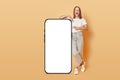 Mobile device display. Blogging on the web. Blank smartphone mockup. Excited amazed brown haired adult woman pointing phone with