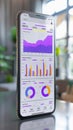 A mobile device presenting data through graphs is placed on a table for viewing Royalty Free Stock Photo