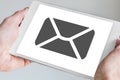 Mobile e-mail and messaging concept displayed on touchscreen of modern tablet held in two hands Royalty Free Stock Photo