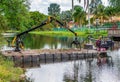 Mobile floating dock with hydraulic grapple loader in a residential canal - Davie, Florida, USA