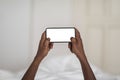 Mobile Gaming. Unrecognizable Black Male Using Blank Smartphone With White Screen, Mockup Royalty Free Stock Photo