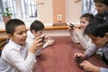 Mobile generation kids using their mobile devices for entertainment Royalty Free Stock Photo