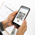 Mobile in hand scanning QR code isolated on white background