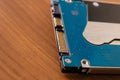 Mobile HDD on wooden desk, hard drive disk closeup - Image Royalty Free Stock Photo