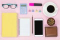 Mobile and old book and notebook pencil glasses black coffee white cup and paper clip cactus on pink background flatlay pastel st Royalty Free Stock Photo