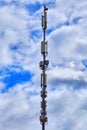 Mobile operator base station. Cellular antenna against the sky and clouds Royalty Free Stock Photo