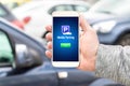 Mobile parking app on smartphone screen facing camera. Royalty Free Stock Photo