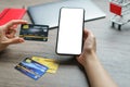 Mobile payments. hands using smartphone and credit card for online shopping Royalty Free Stock Photo