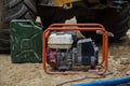 Mobile petrol power generator and jerry can with petrol on building site Royalty Free Stock Photo