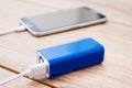 Mobile phone and battery power bank charger on a office desk Royalty Free Stock Photo