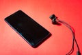 Mobile phone with black headset on a colorful background Royalty Free Stock Photo