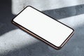 Mobile phone with blank screen and golden frames isolated on concrete background. 3d rendering. Royalty Free Stock Photo