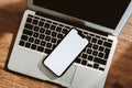 Mobile phone with blank white mockup touchscreen and laptop computer on office desk, top view Royalty Free Stock Photo