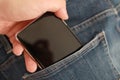 Mobile phone in blue denim jeans pant pocket, pocketing smartphone Royalty Free Stock Photo