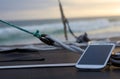 Mobile phone on a boat at sunset Royalty Free Stock Photo