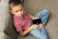 Mobile phone in boy hands with black blank touchscree