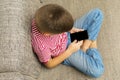 Mobile phone in boy hands with black blank touchscree