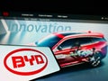 Mobile phone with business logo of Chinese car manufacturer BYD Co. Ltd. on screen in front of website. Royalty Free Stock Photo