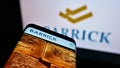 Mobile phone with business webpage of Canadian mining company Barrick Gold Corp. on screen in front of logo.