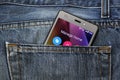 Mobile phone, cellphone in back pocket blue jeans Royalty Free Stock Photo