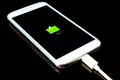 mobile phone is charging on a black background Royalty Free Stock Photo