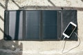 Mobile phone is charging from the solar panel Royalty Free Stock Photo