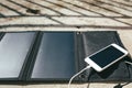 Mobile phone is charging from the solar panel Royalty Free Stock Photo