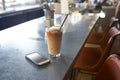 Mobile Phone And Cold Press Coffee On Cafe Counter