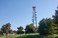 Mobile phone communication antenna tower with the blue sky near a residential community Royalty Free Stock Photo