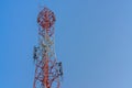 Mobile phone communication antenna tower with satellite dish on blue sky background Royalty Free Stock Photo