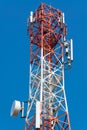 Mobile phone communication antenna tower with satellite dish on blue sky background Royalty Free Stock Photo