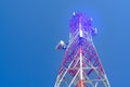 Mobile phone communication antenna tower with satellite dish on blue sky background Royalty Free Stock Photo