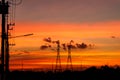 The Mobile phone communication antenna tower with silhouette in sunset sky background Royalty Free Stock Photo
