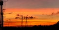 Two Mobile phone communication antenna tower with silhouette in sunset sky background Royalty Free Stock Photo